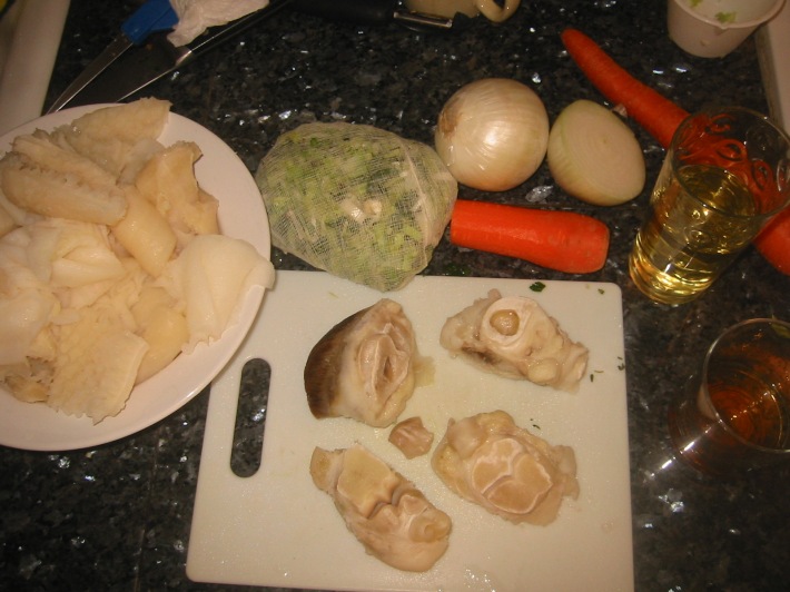 From left to right: tripes, aromatic cheese-cloth bundle, ox feet, onions, carrots, wine, and calvados.